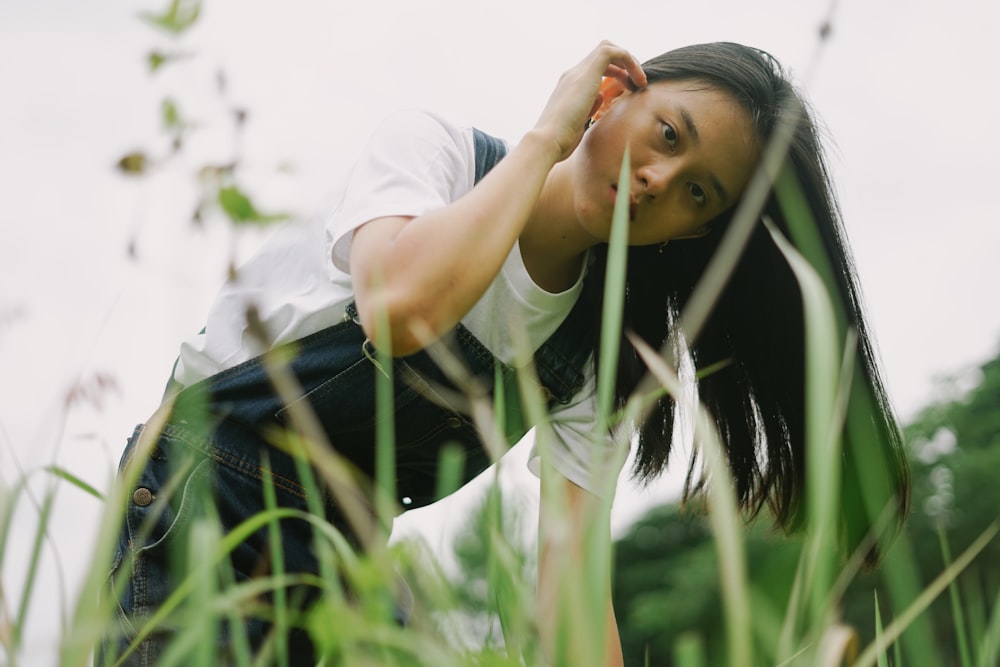 woman in white t-shirt and blue denim jeans