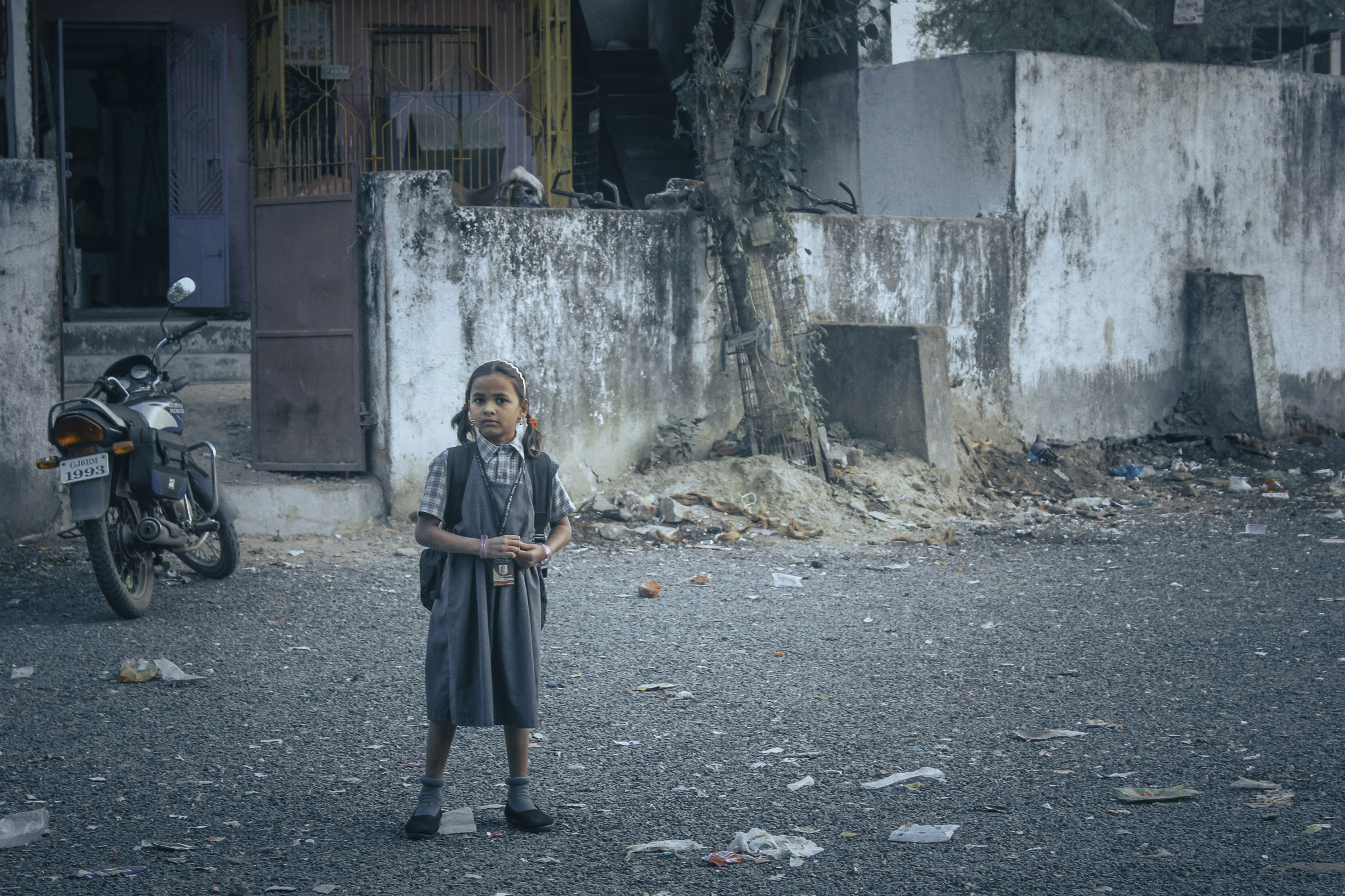 woman in black coat standing on gray concrete floor