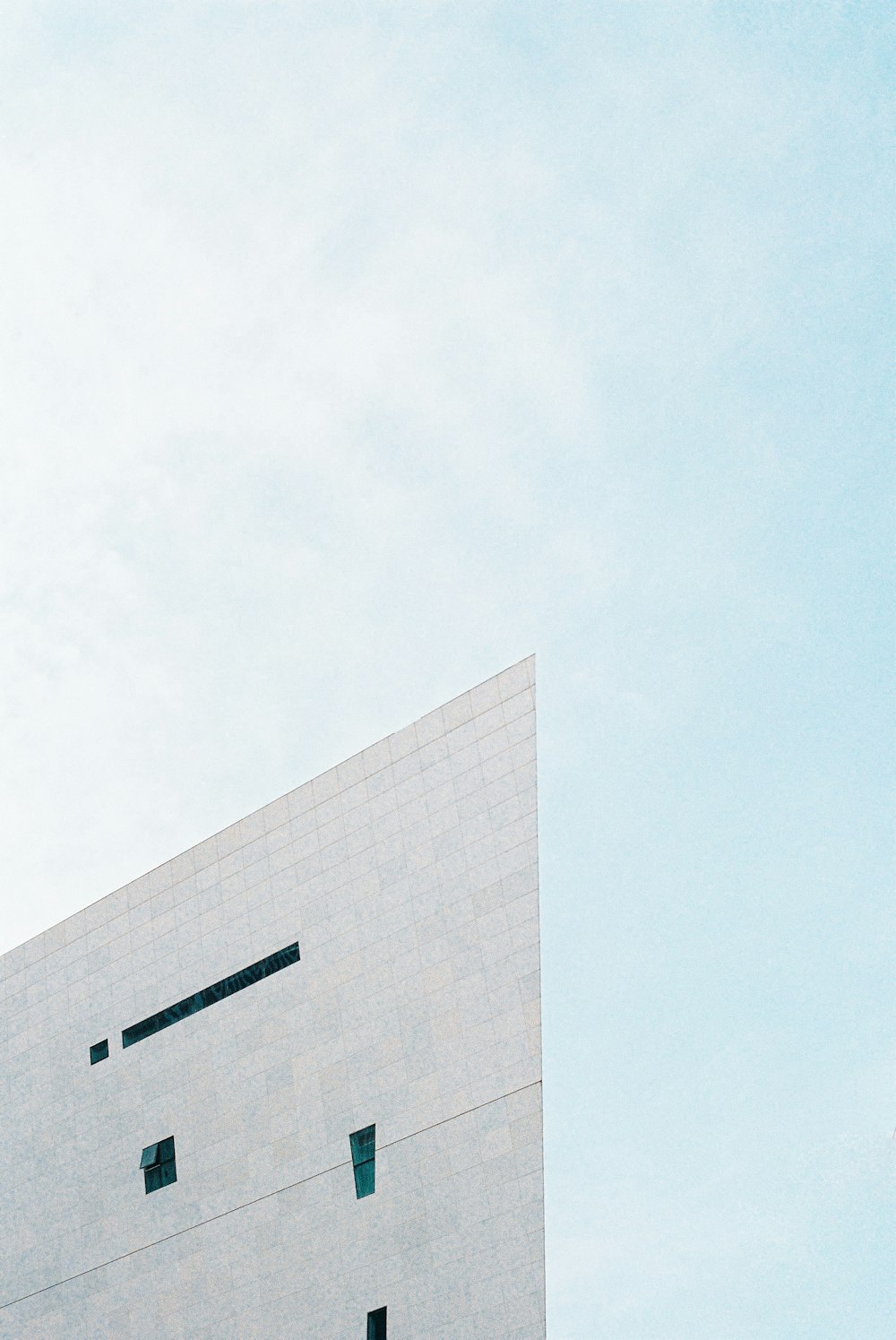 white concrete building under white sky during daytime