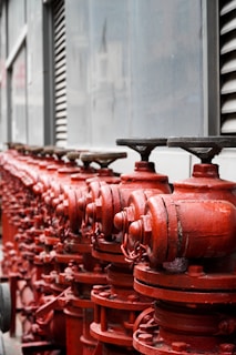 red metal pipe lot during daytime