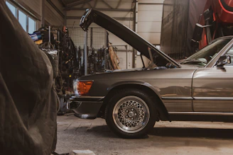 a car with its hood open in a garage