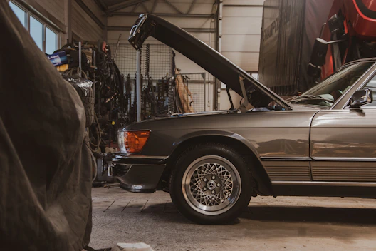 a car with its hood open in a garage