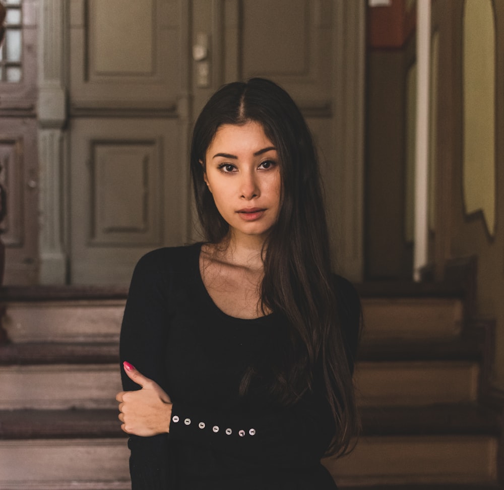 a woman standing in front of a set of stairs