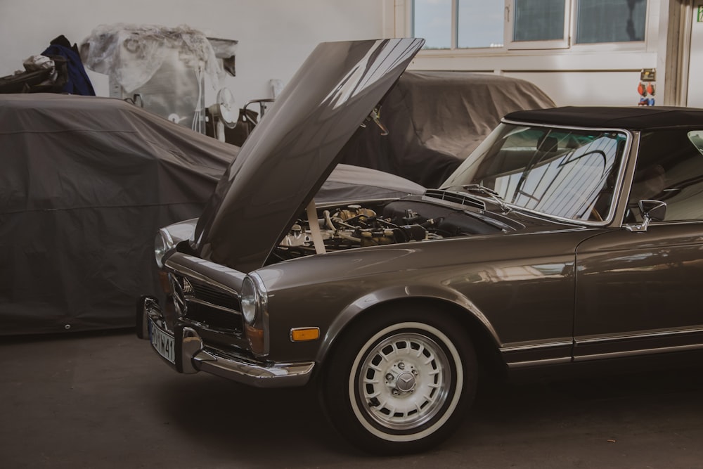 a car with its hood open in a garage