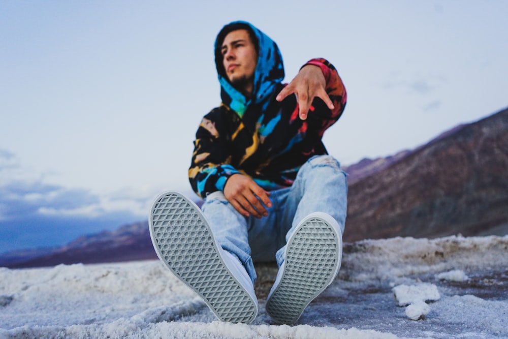 a man sitting on the ground with his feet up