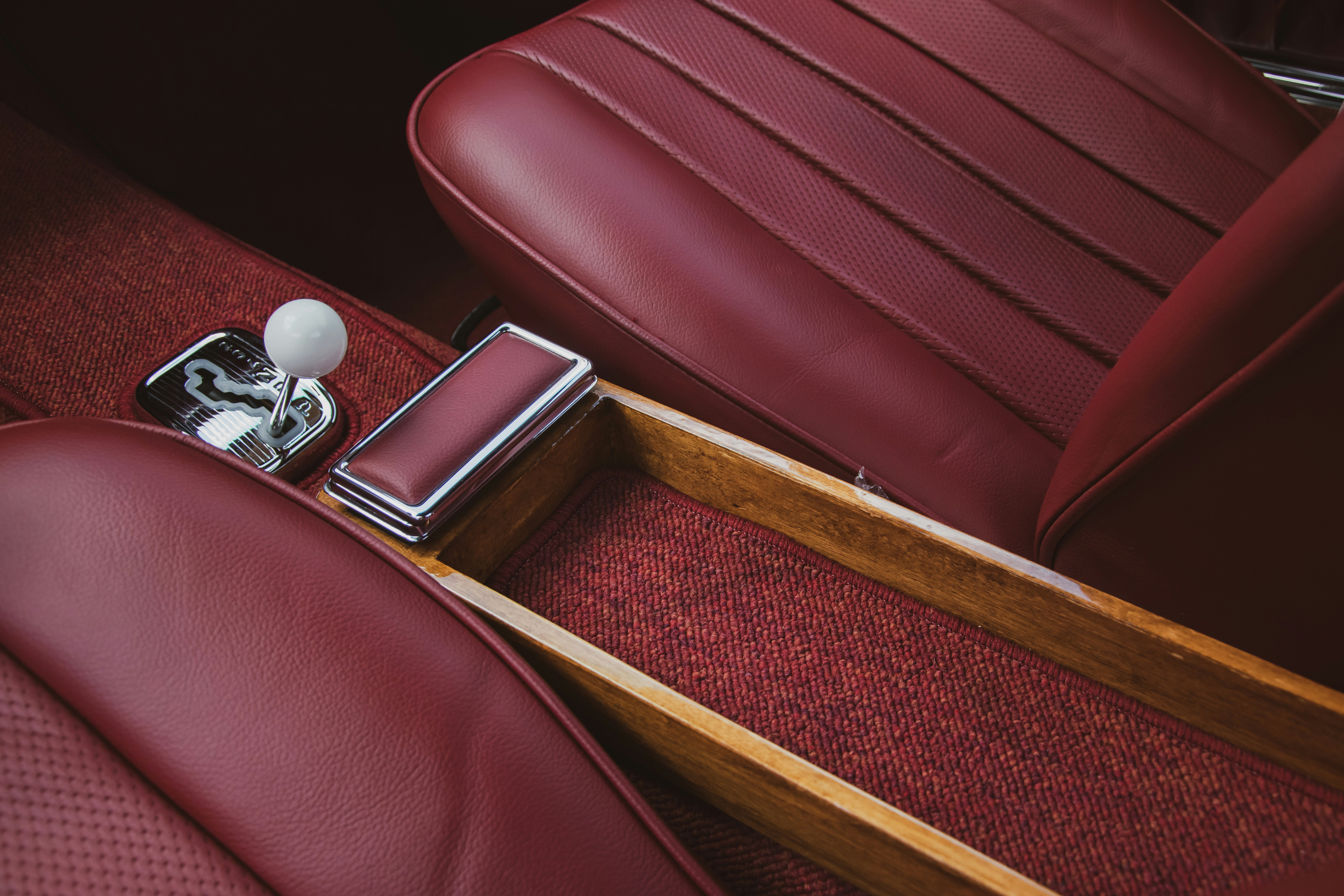 the interior of a car with red leather seats