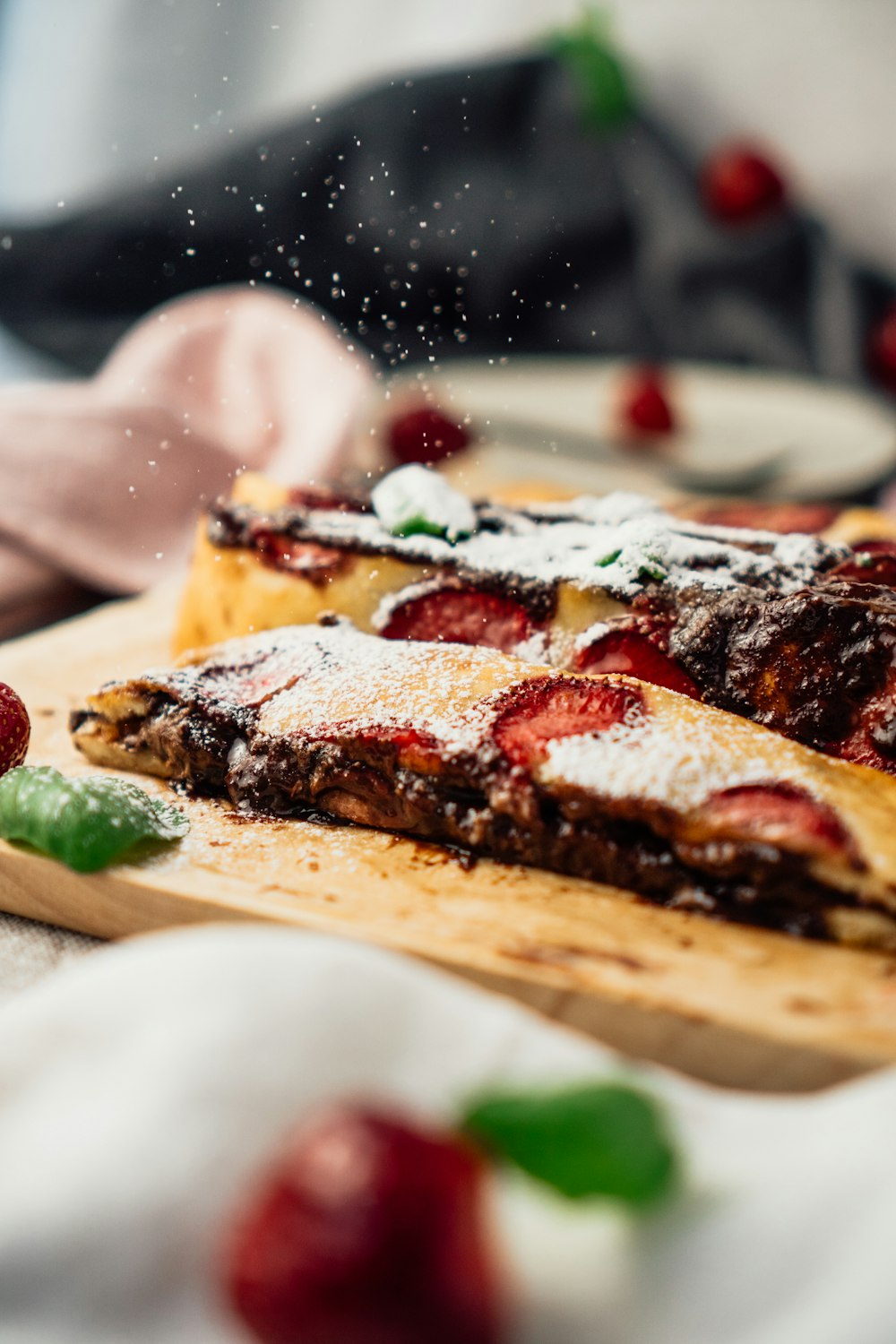 a wooden cutting board topped with slices of pizza