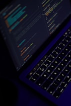 black laptop computer turned on showing microsoft word
