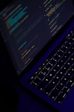 black laptop computer turned on showing microsoft word