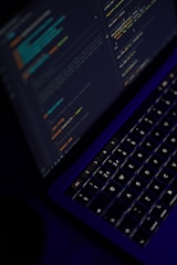 black laptop computer turned on showing microsoft word