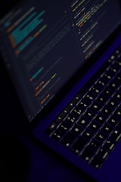black laptop computer turned on showing microsoft word