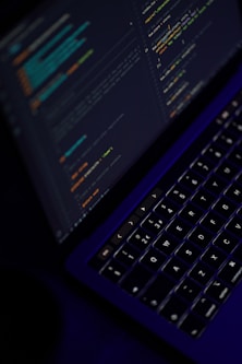 black laptop computer turned on showing microsoft word