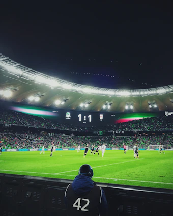 A sleek dark-themed football scoreboard displaying live match updates on a mobile device.
