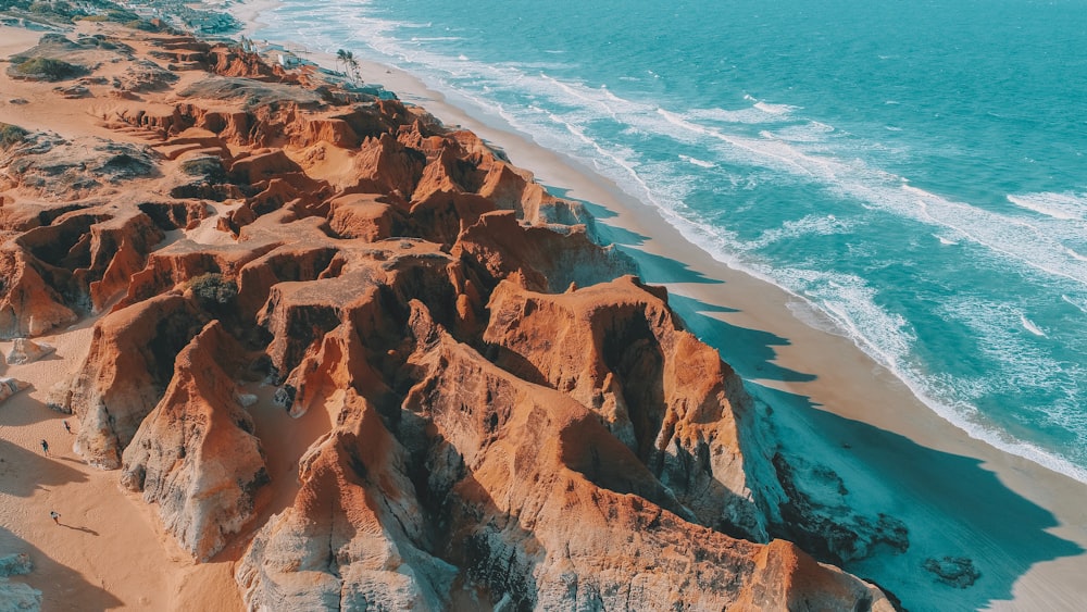 an aerial view of a sandy beach and ocean