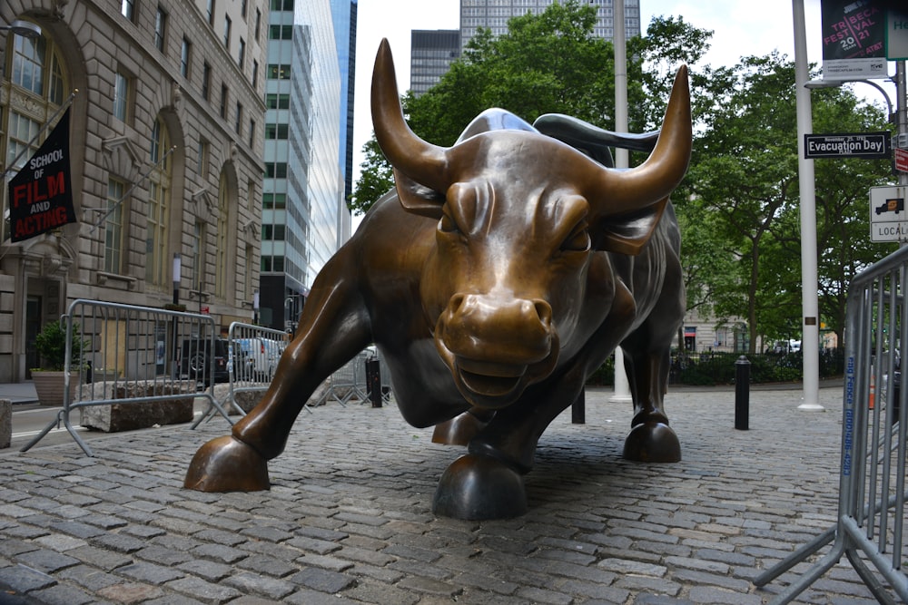 brown and black cow statue on gray brick floor