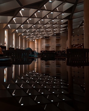 Students enjoying shared spaces with elegant dark decor and golden lighting
