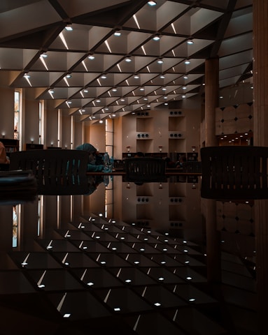 A calm study space featuring Islamic art and children engaging in thoughtful reading.