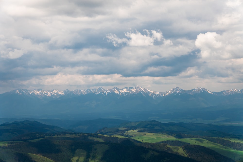 green mountains under white clouds during daytime