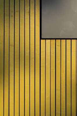 a yellow wall with a sign on it