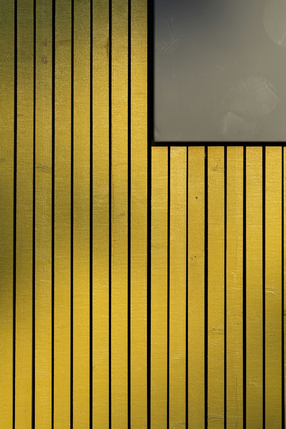 a yellow wall with a sign on it