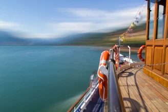 A panoramic view of a boat deck equipped with navigation and safety systems under a bright blue sky.