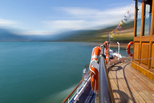 A panoramic view of a boat deck equipped with navigation and safety systems under a bright blue sky.