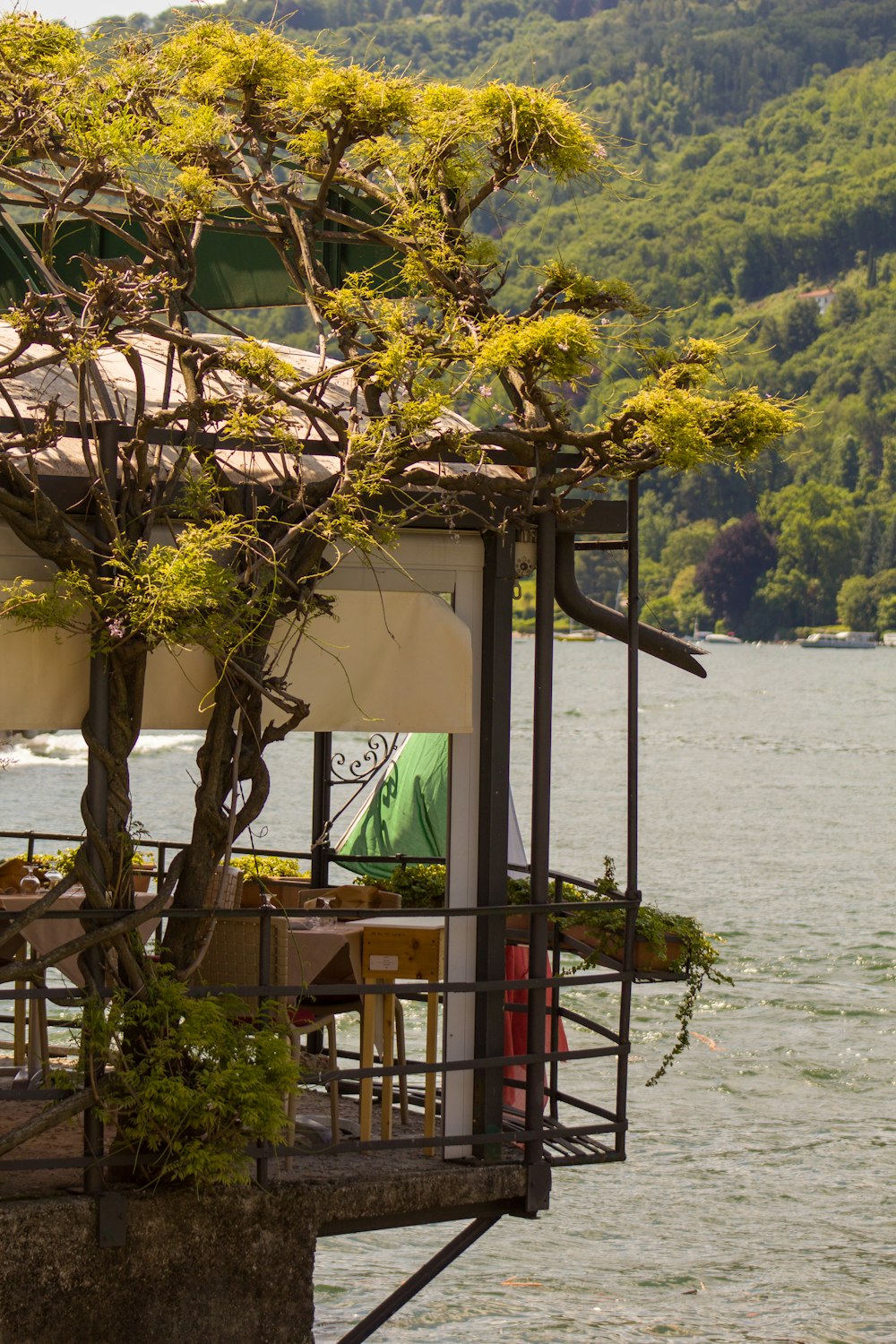 a gazebo sitting on the side of a body of water