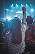 a group of people standing in front of a stage