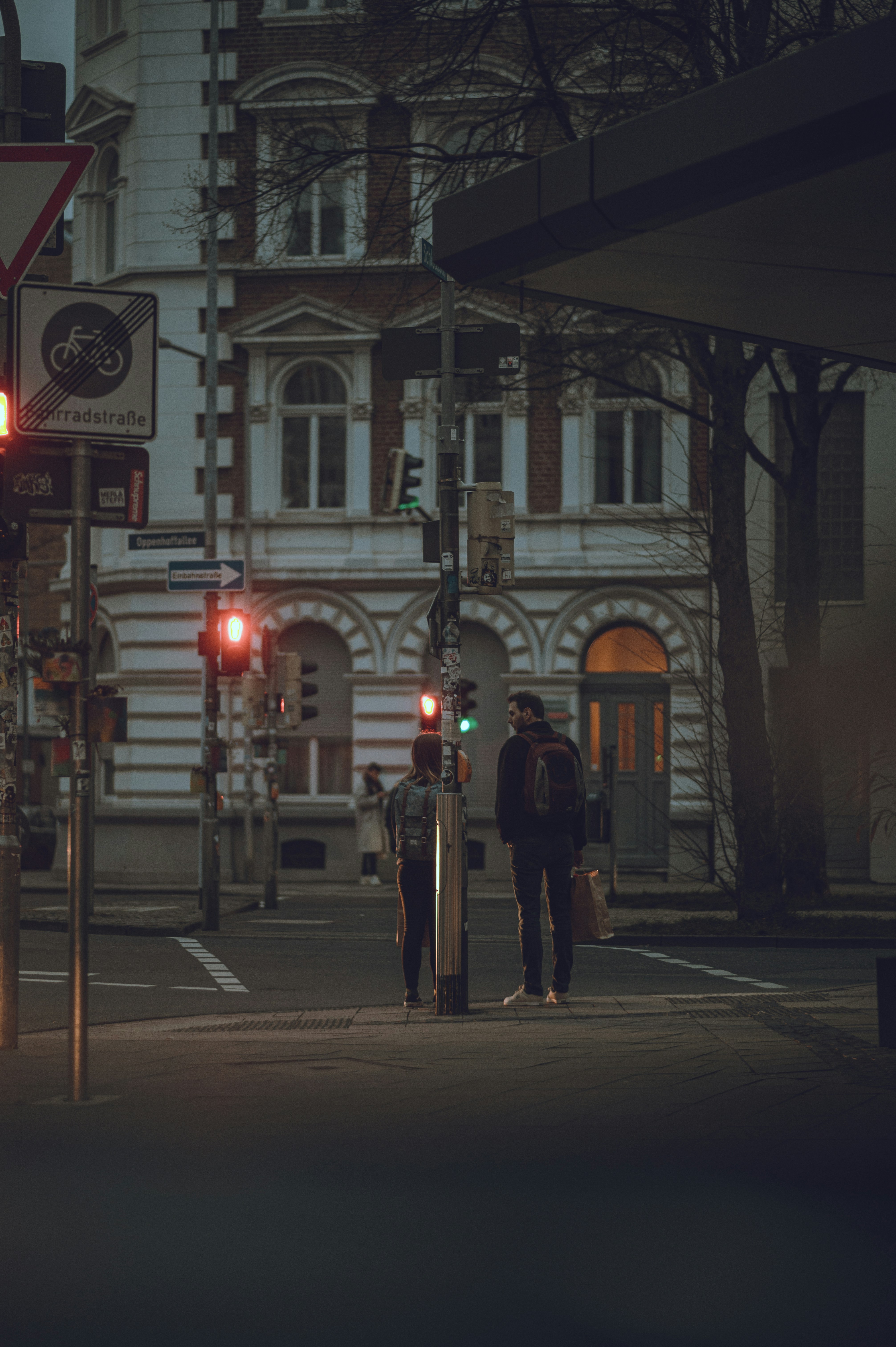 people walking on sidewalk during night time