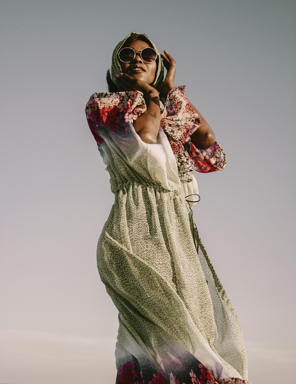 a woman in a floral dress is talking on a cell phone