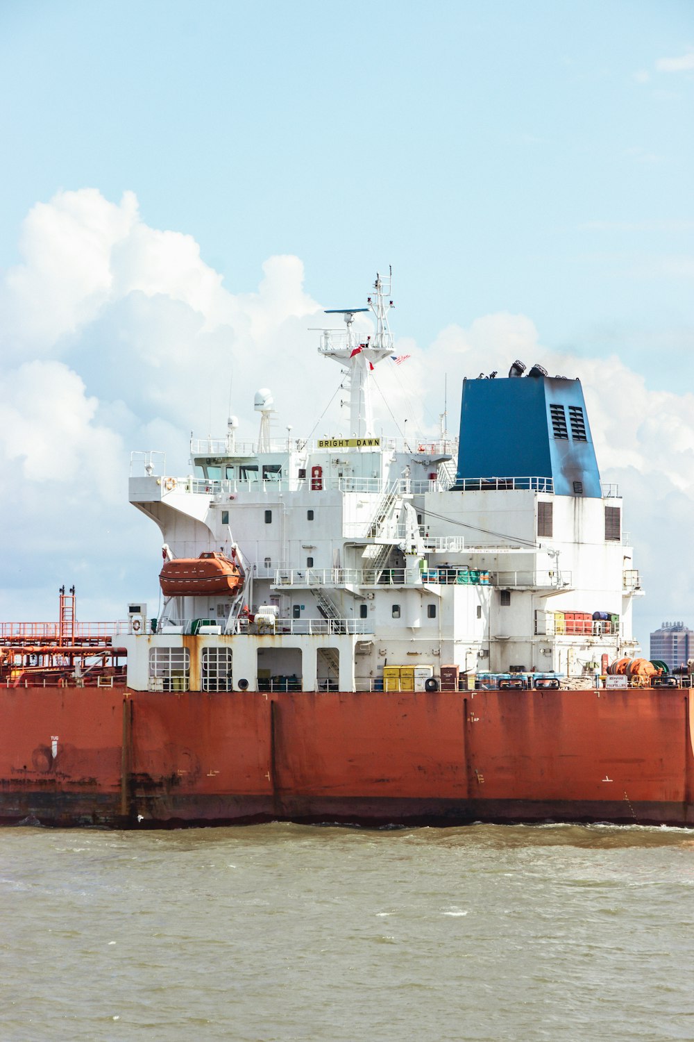 a large red and white ship in the water