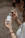 a woman holding a bottle of perfume in her hand