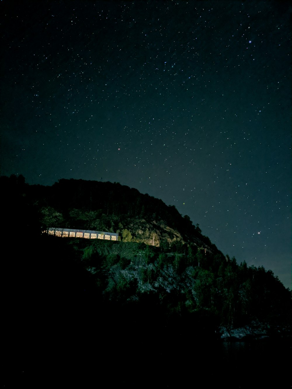 white bridge on top of mountain during night time