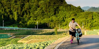 man in gray t-shirt and black shorts walking on gray concrete pathway during daytime