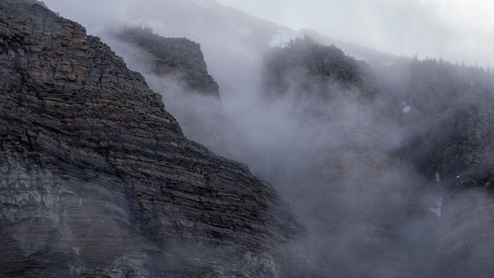 brown rocky mountain with fog