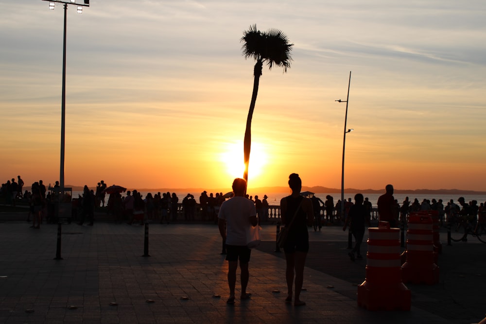 people walking on the street during sunset