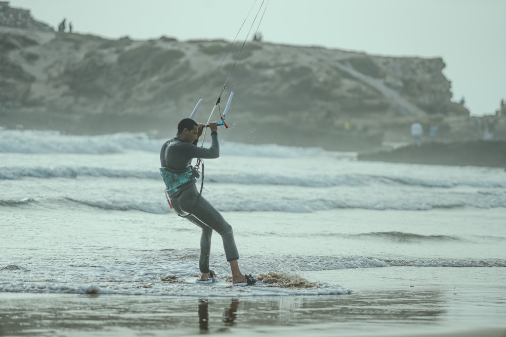 a man on the beach with a kite