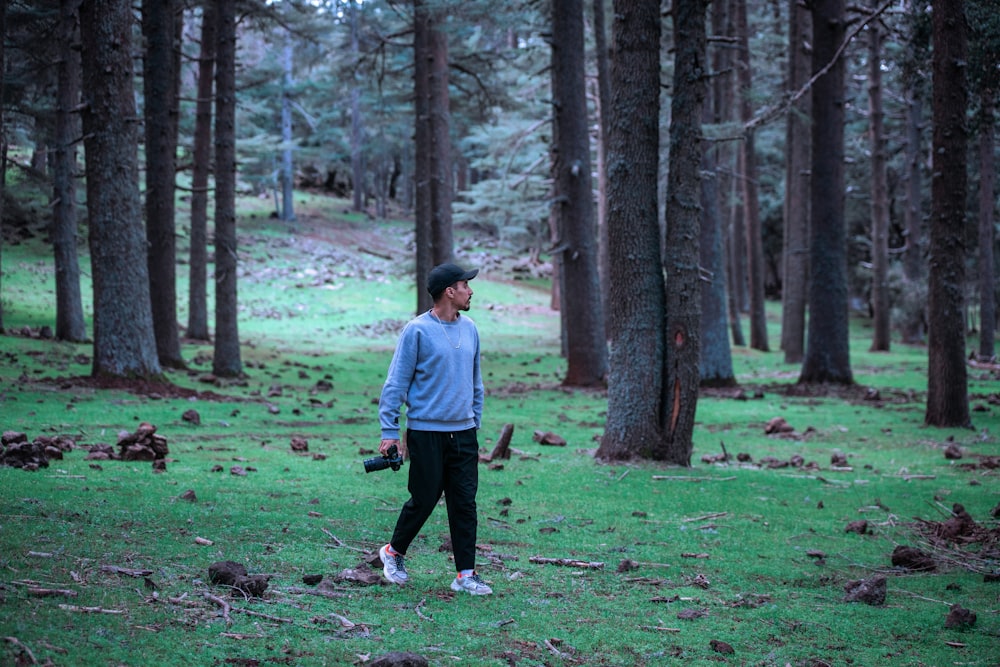 a man standing in the middle of a forest