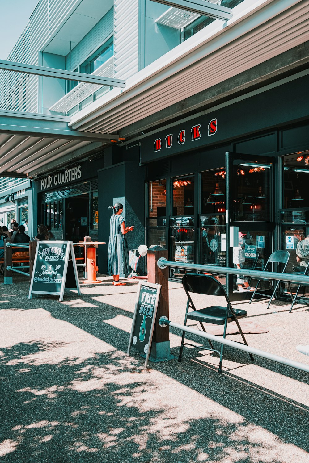 a store front with a sign and a bench in front of it