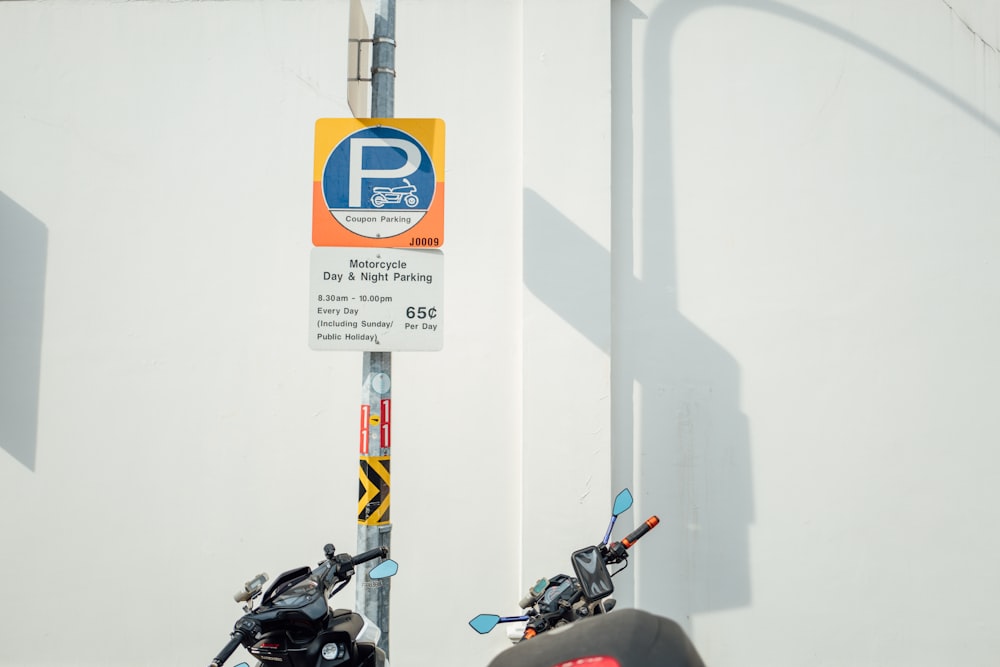 a motorcycle parked next to a parking sign