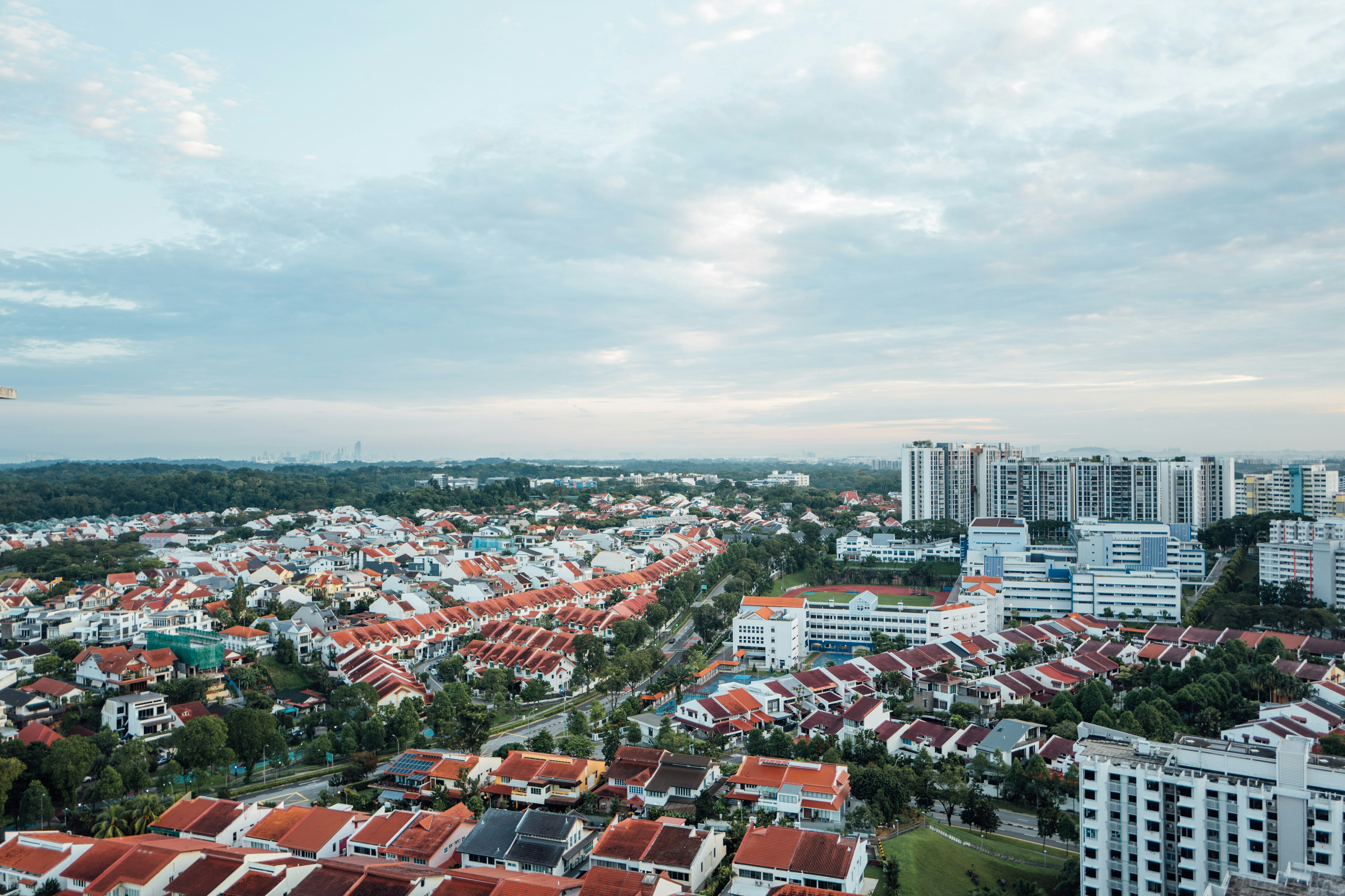 an aerial view of a city with red roofs