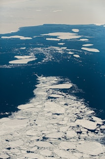 an aerial view of ice floes in the ocean