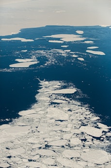 an aerial view of ice floes in the ocean