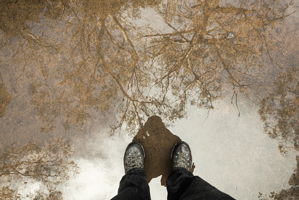 a person standing in front of a puddle of water