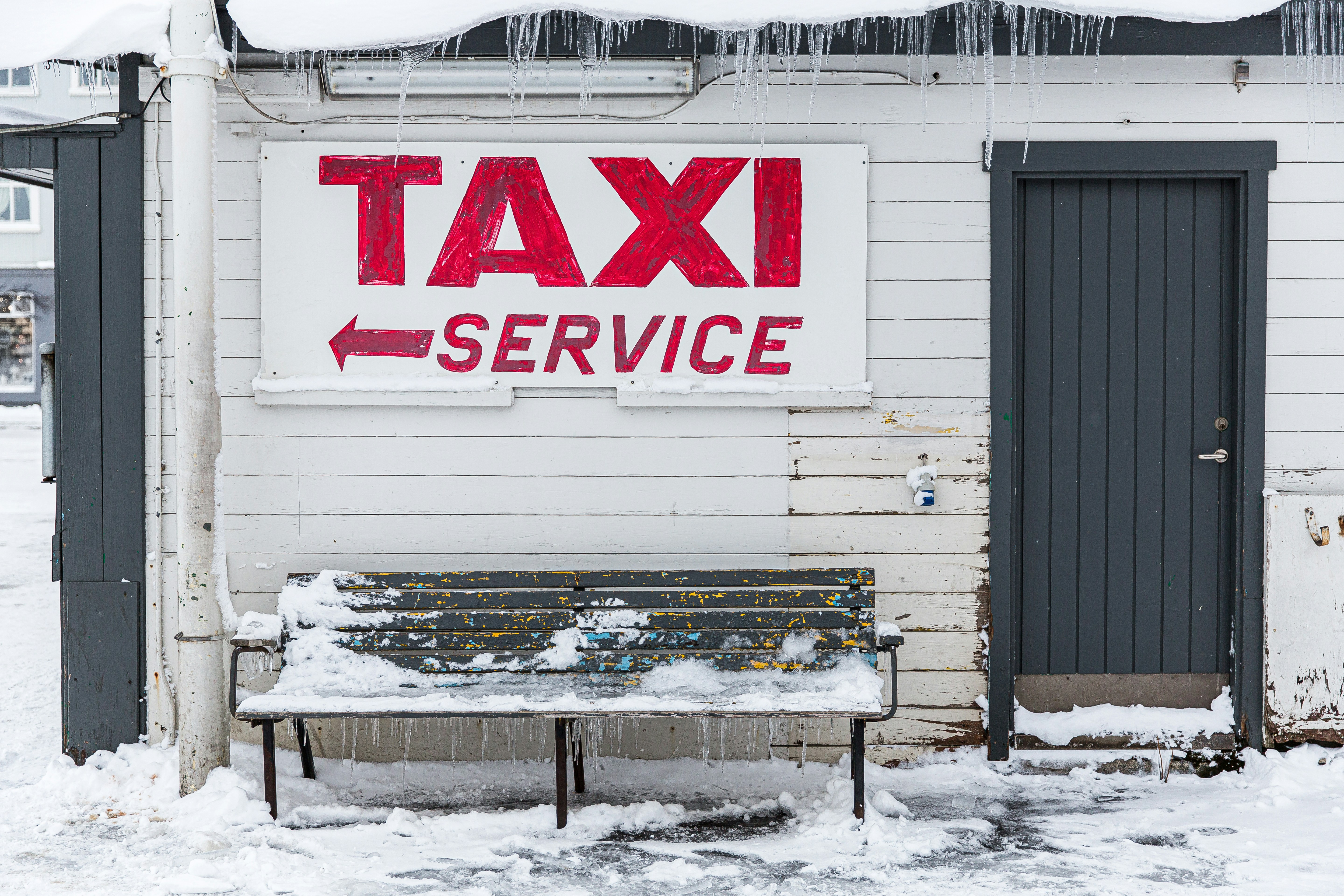 Signage and bench in Iceland during winter.
