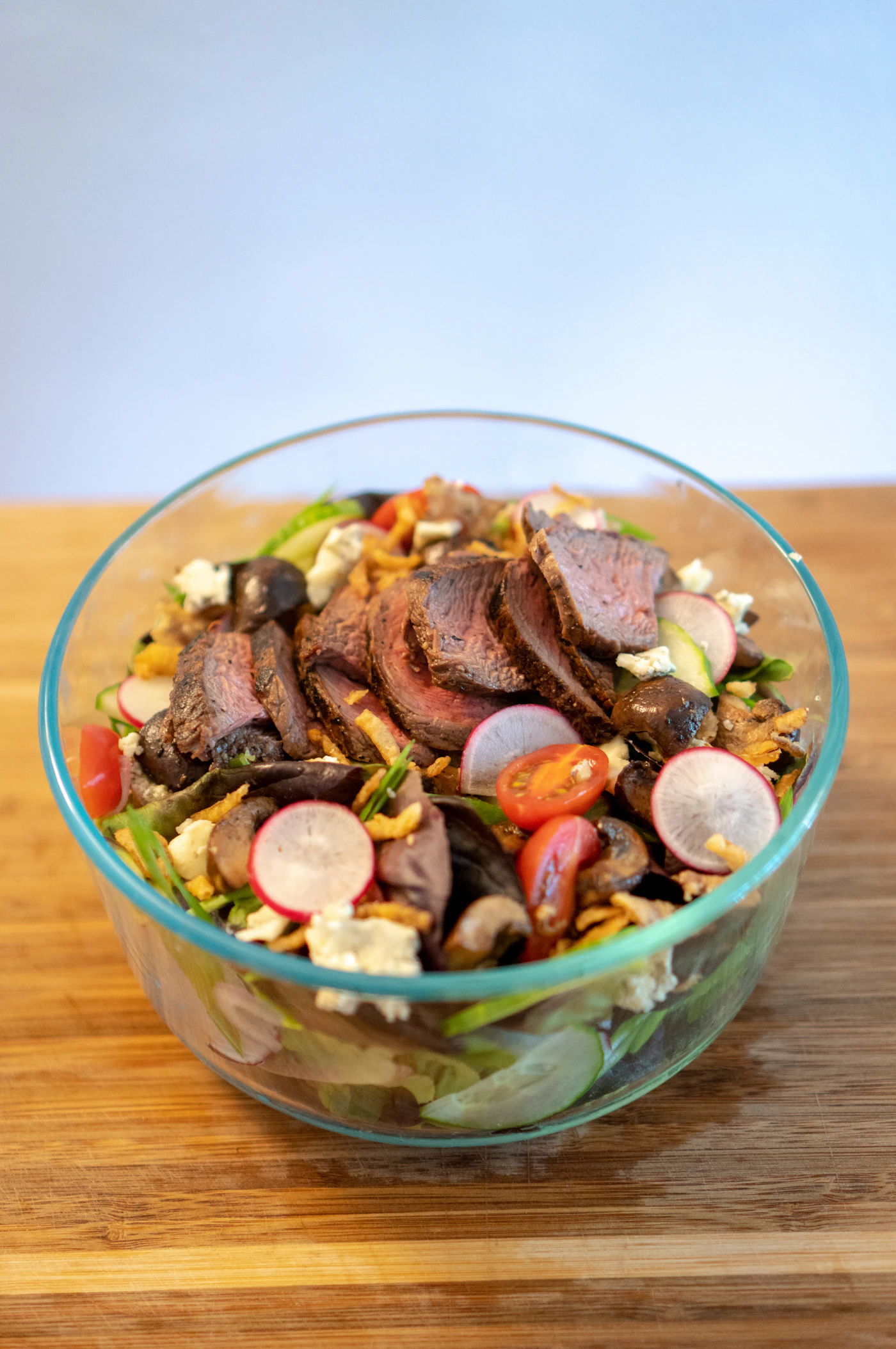 Steak salad with radish greens cucumber and sesame lime dressing