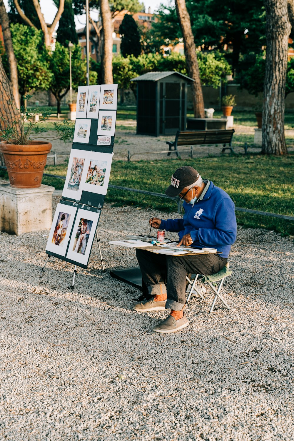 a man sitting at a table in front of a sign