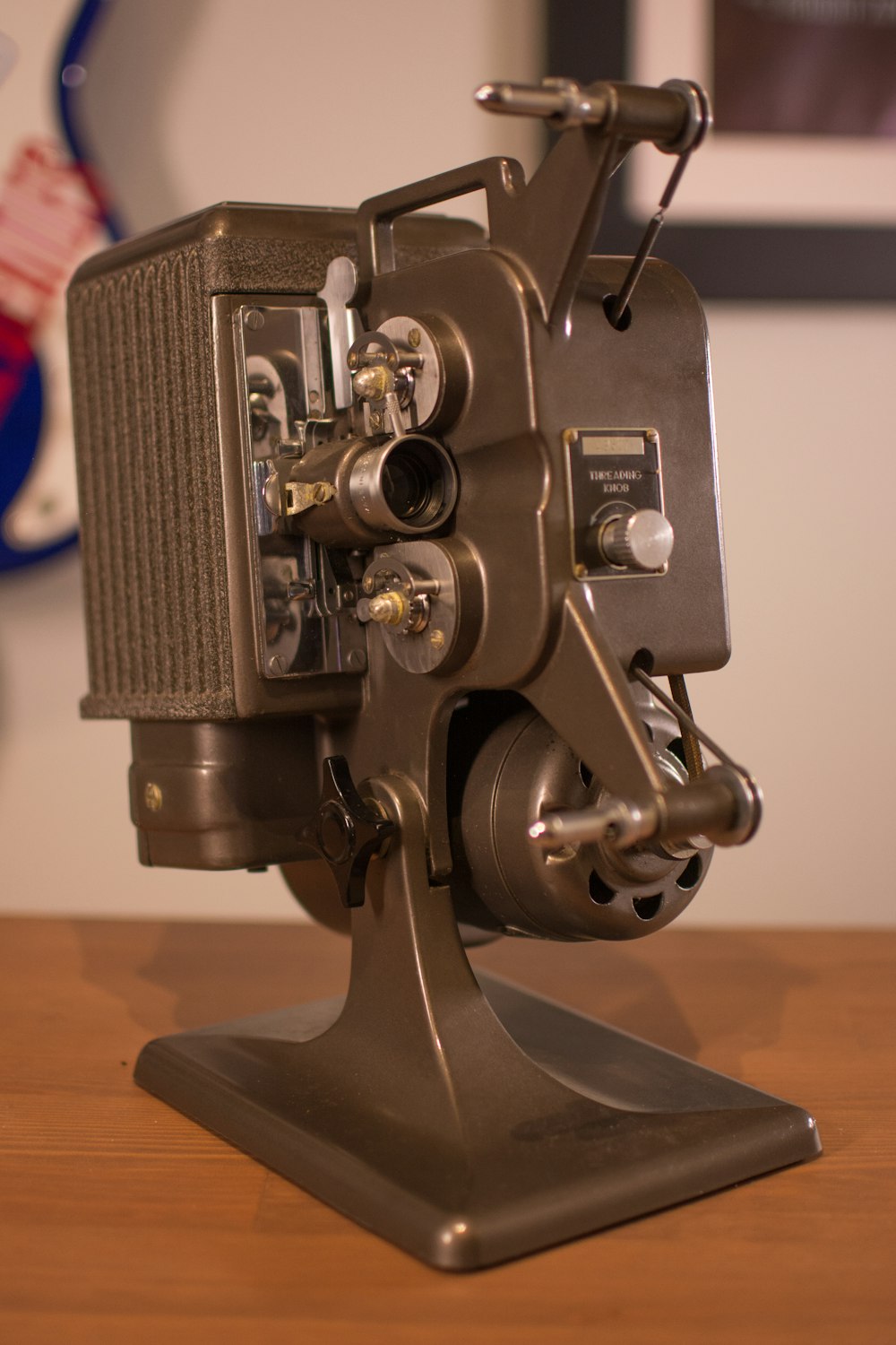an old movie projector sitting on top of a wooden table