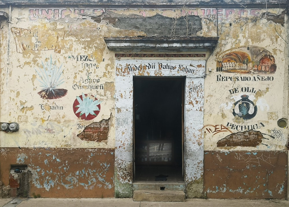 an old building with a door and some signs on it