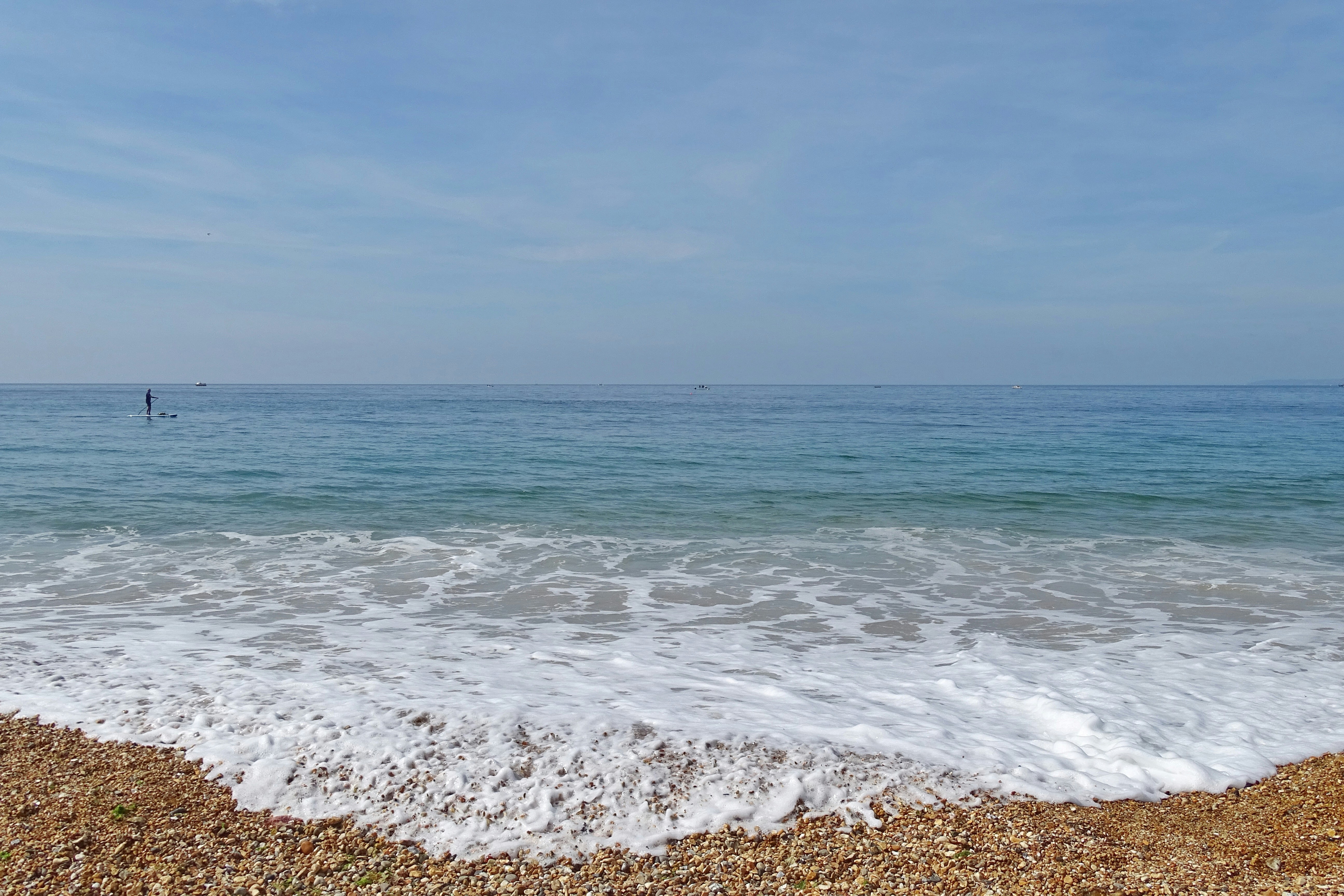 a view of the ocean from the shore of a beach